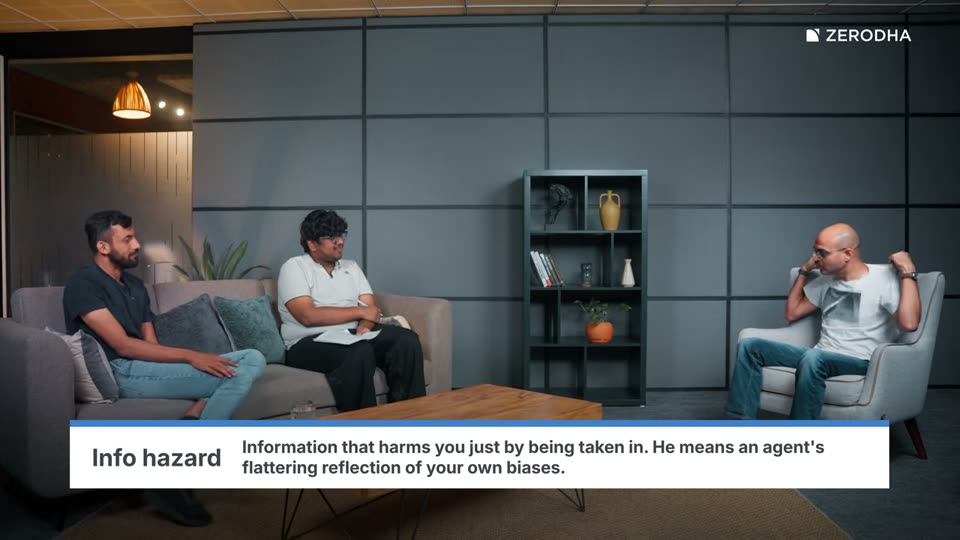 On-screen card: Info hazard. Information that harms you just by being taken in. He means an agent's flattering reflection of your own biases.