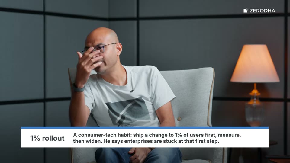On-screen card: 1% rollout. A consumer-tech habit: ship a change to 1% of users first, measure, then widen. He says enterprises are stuck at that first step.
