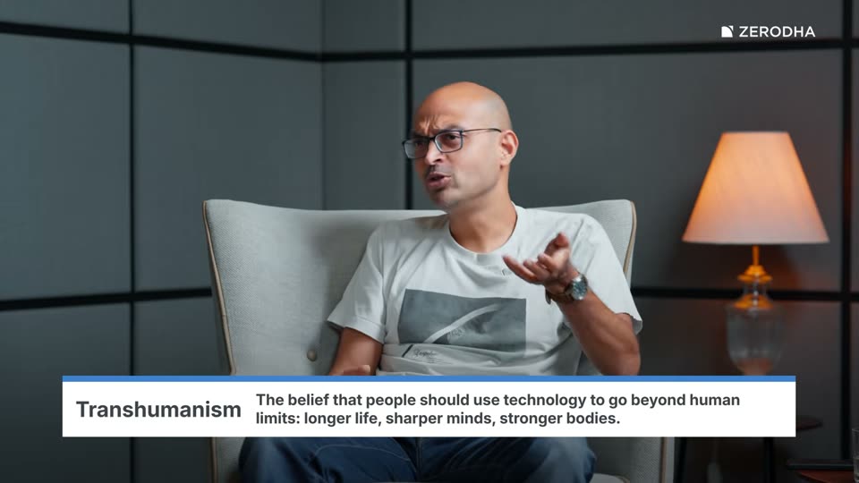 On-screen card: Transhumanism. The belief that people should use technology to go beyond human limits: longer life, sharper minds, stronger bodies.